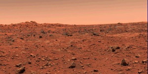 This color picture of Mars was taken July 21--the day following Viking l's successful landing on the planet. The local time on Mars is approximately noon. The view is southeast from the Viking. Orange-red surface materials cover most of the surface, apparently forming a thin veneer over darker bedrock exposed in patches, as in the lower right. The reddish surface materials may be limonite (hydrated ferric oxide). Such weathering products form on Earth in the presence of water and an oxidizing atmosphere. The sky has a reddish cast, probably due to scattering and reflection from reddish sediment suspended in the lower atmosphere.