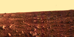 This color image of the Martian surface in the Chryse area was taken by Viking Lander 1, looking southwest, about 15 minutes before sunset on the evening of August 21. The sun is at an elevation angle of 3 or 4 degrees above the horizon and about 50 degrees clockwise from the right edge of the frame. Local topographic features are accentuated by the low lighting angle. A depression is seen near the center of the picture, just above the Lander’s leg support structure, which was not evident in previous pictures taken at higher sun angles.