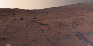Martian skies seen above a rolling horizon in this image, part of a larger image called the McMurdo panorama, taken in the Martian winter of 2006 by NASA's Mars Exploration Rover Spirit. The tracks in the soil are from Spirits wheels as it rolled through the area earlier. (NASA/JPL/Cornell)